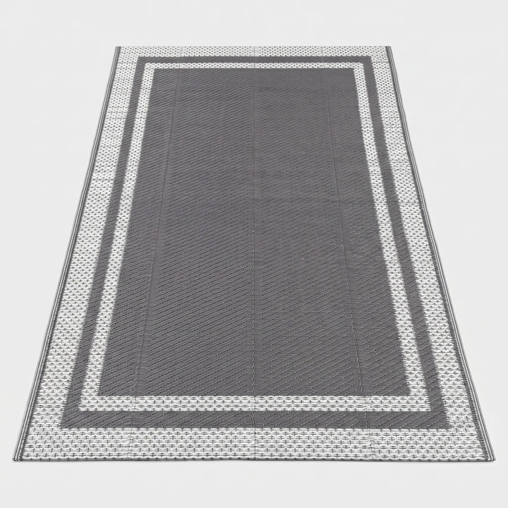 Reversible grey white rectangular outdoor mat, ideal for patio & deck. Modern geometric design, easy to clean & portable floor covering.