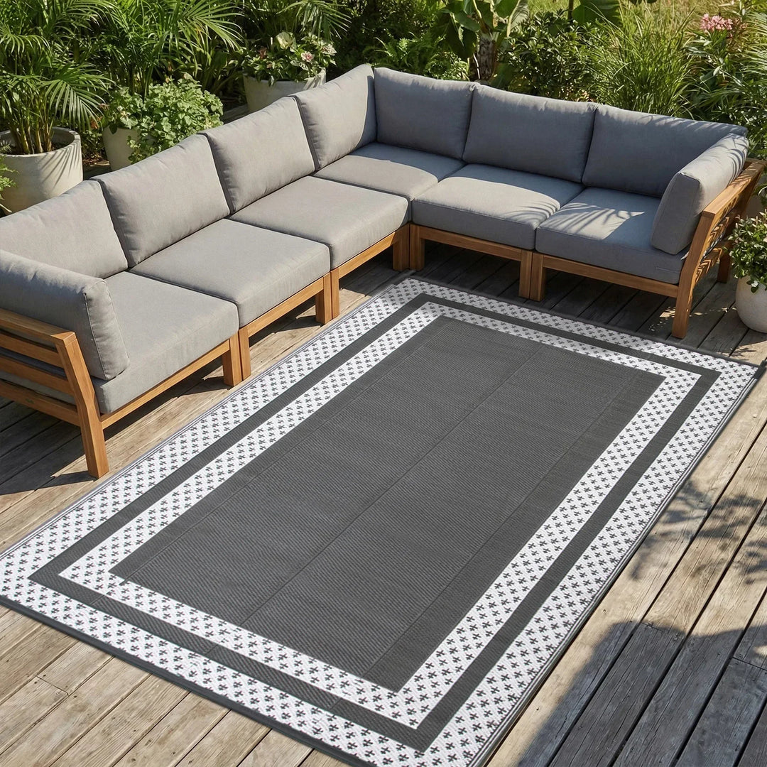 Modern grey white geometric outdoor mat, a stylish reversible floor covering for patios, decks, and camping. Easy-clean design.