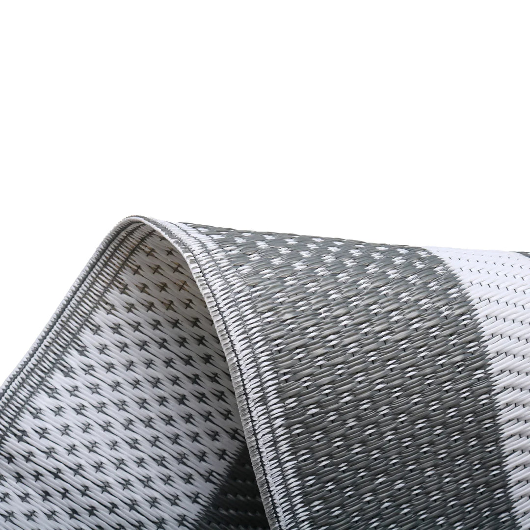 Versatile grey white modern outdoor area mat. Reversible geometric design for patio, deck, camping, or picnic essential. Portable.