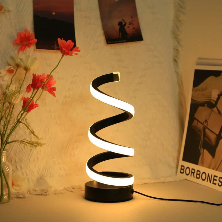 Modern S-shaped LED desk lamp, black, for home office. Eye-caring work light, USB powered, contemporary design.