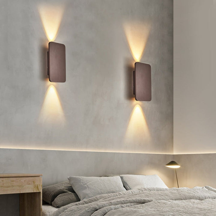 Sleek square modern wall lamp provides elegant accent lighting for any indoor living space or hallway.
