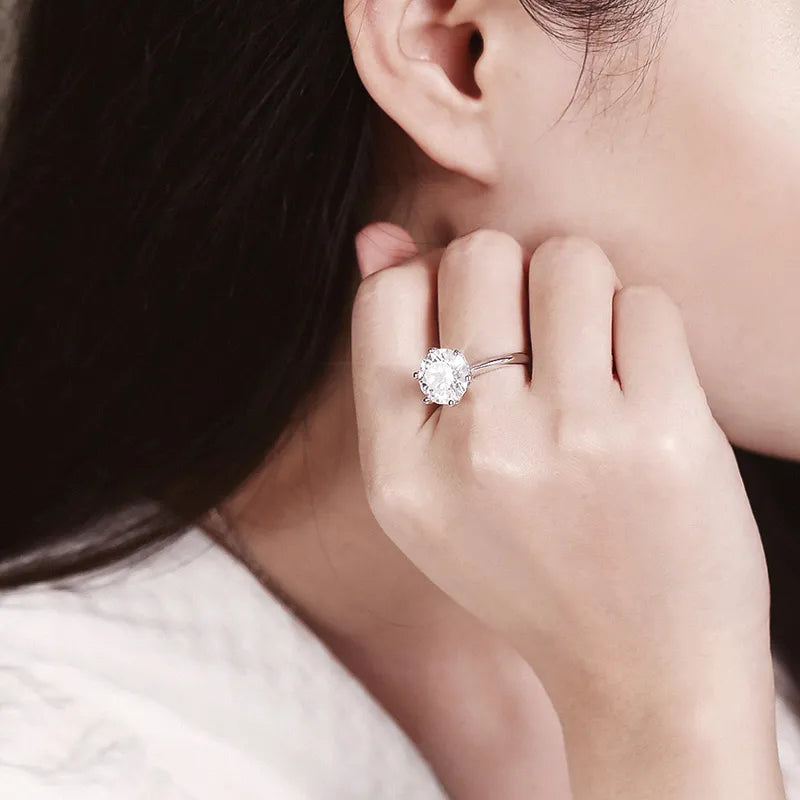 Classic women's brilliant cut moissanite solitaire engagement ring, sterling silver.