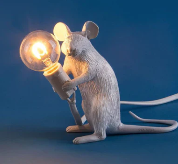 Elegant gold mouse table lamp with white shade, a charming decorative accent for modern and playful homes.