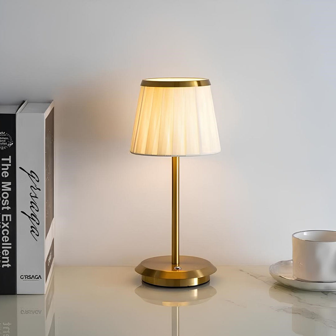 Unisex gold table lamp with fabric shade & modern aesthetic. A stylish rechargeable & dimmable LED light for decor.