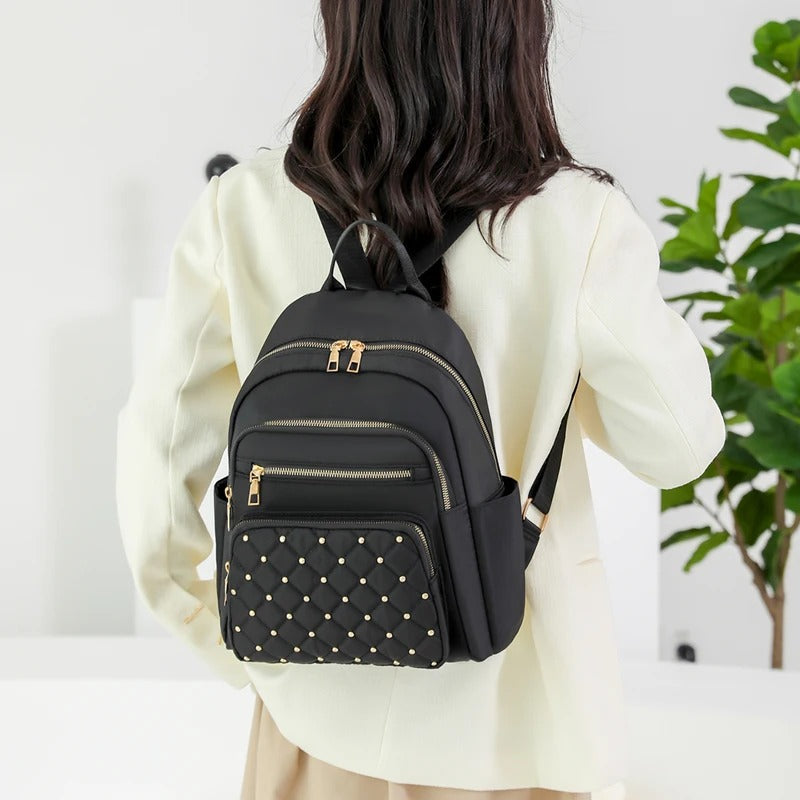 Lightweight travel backpack for women, water-resistant nylon design, perfect for school or a daily commuter bag.