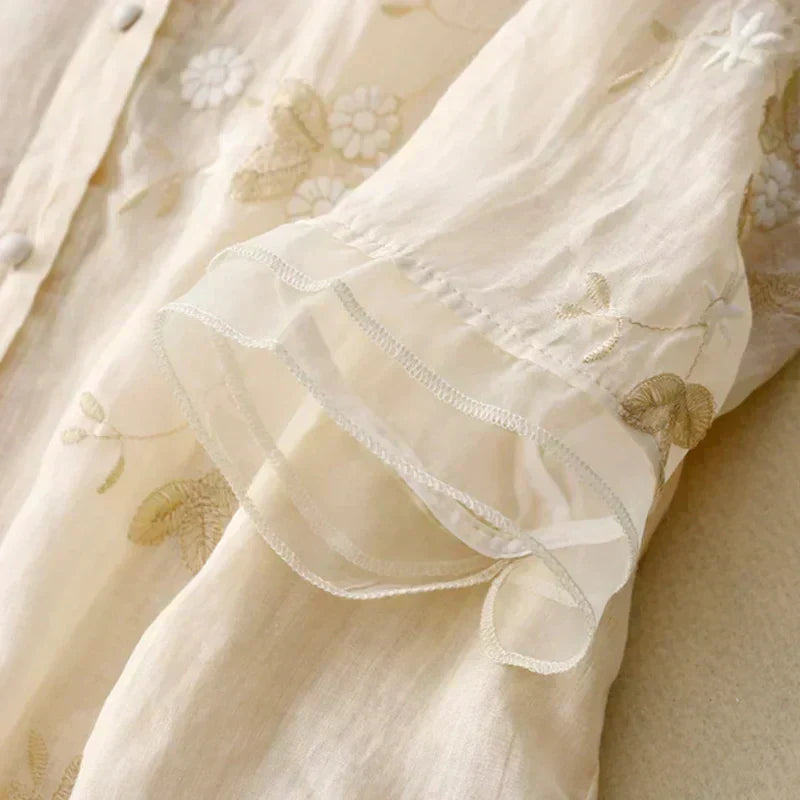 Elegant women's loose fit blouse with delicate floral embroidery. Perfect for casual chic spring style.