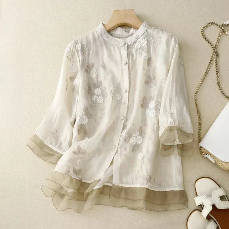 Chic women's loose blouse with floral embroidery. Comfortable & versatile for spring & summer style.