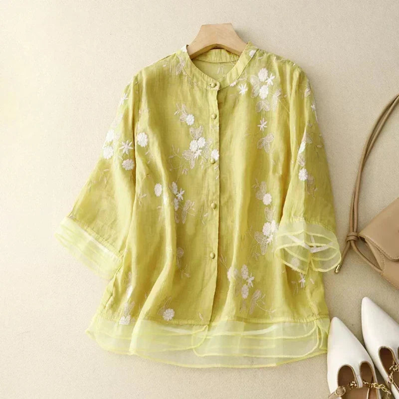 Women's long sleeve floral embroidered loose blouse with mesh cuffs. Ideal for effortless spring style.