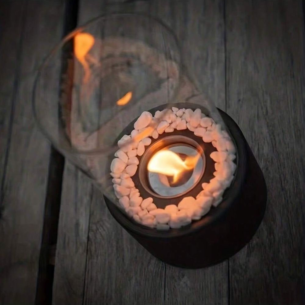 Decorative glass tabletop oil lamp with metal accents, enhancing elegant home decor and indoor ambiance.