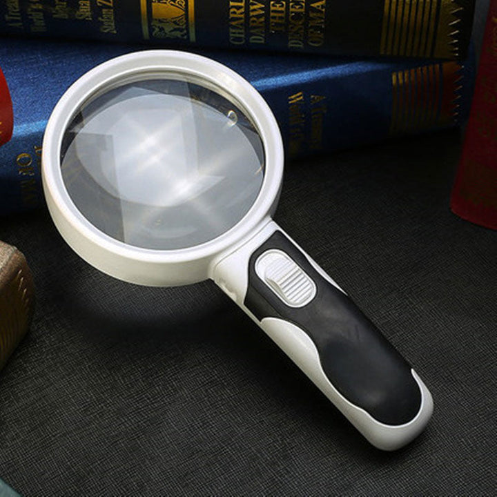 Clear acrylic reading magnifier with bright LED lights for enhanced vision, ideal for elderly.