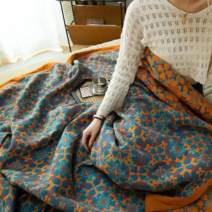 Warm & soft six-layer cotton quilt in vibrant orange & blue pattern, perfect for bedding.