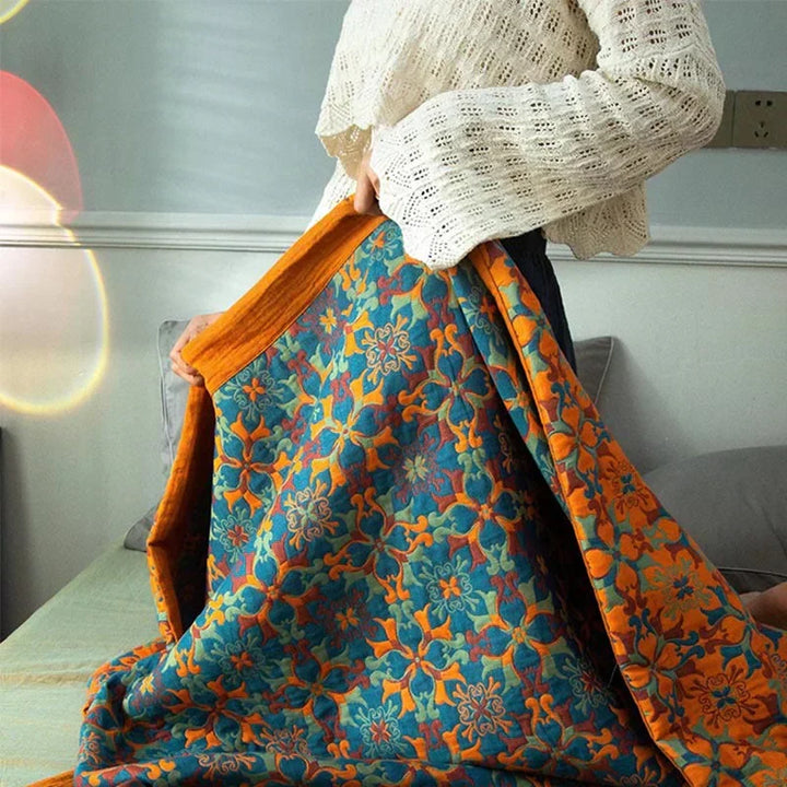 Detailed close-up of orange & blue patterned cotton quilt, showing six-layer texture.