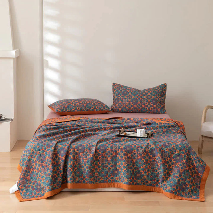 Cozy TerraLoom orange & blue patterned cotton quilt, ideal for comfort and warmth.