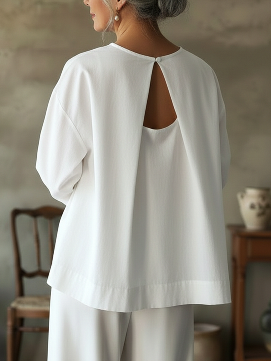 Back view of a women's loose fit long sleeve blouse, showcasing the relaxed silhouette and comfortable design.