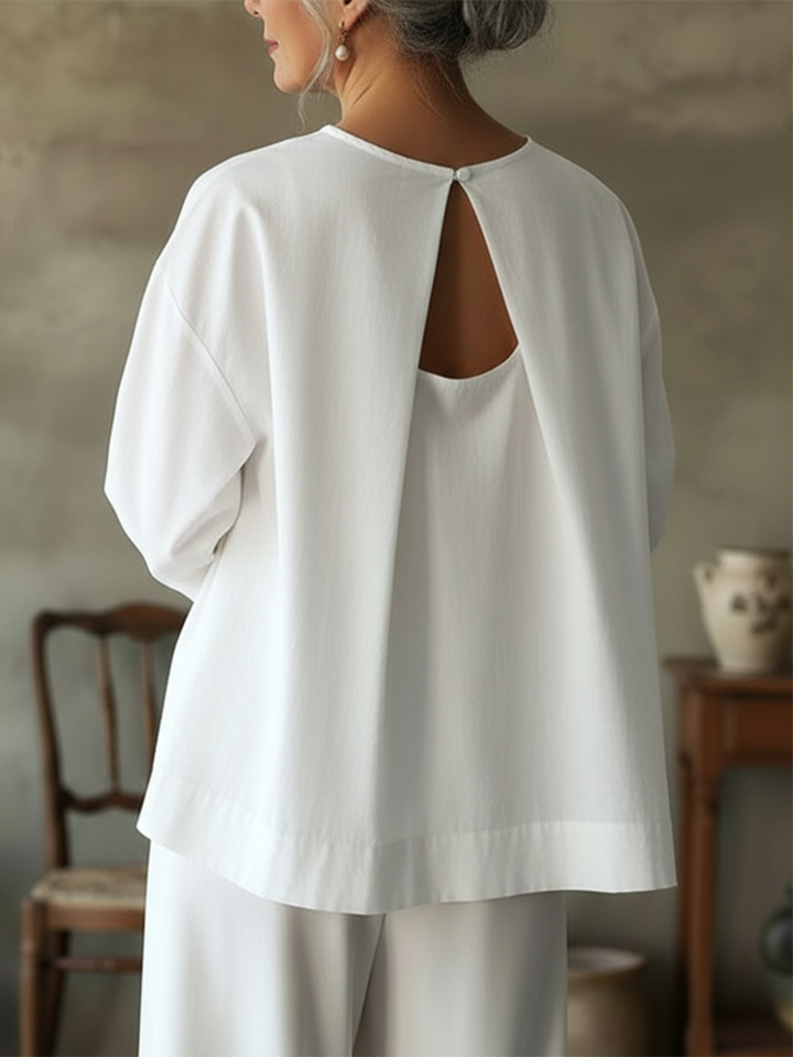 Back view of a women's loose fit long sleeve blouse, showcasing the relaxed silhouette and comfortable design.