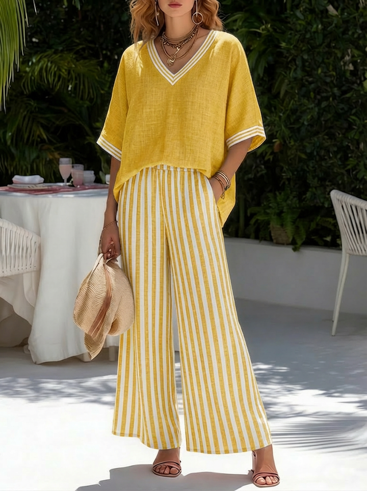 Chic V-neck top and elegant striped wide leg trousers. Women's coordinated two-piece ensemble.