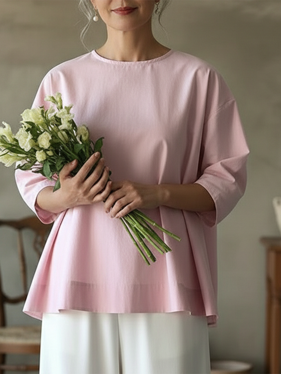 Model wears chic women's loose fit long sleeve blouse with crew neck for a relaxed, versatile look.