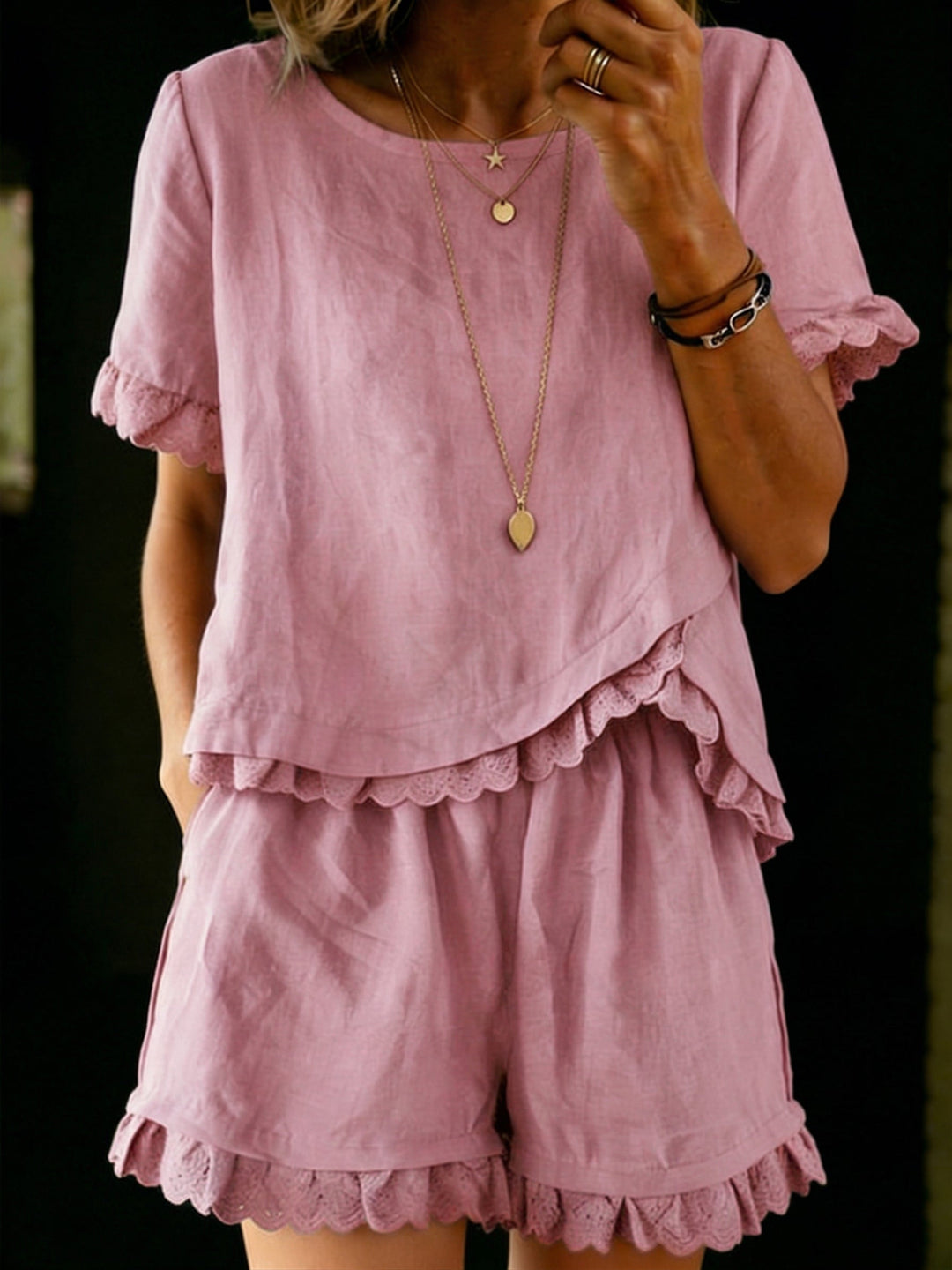 Trendy women's spring/summer outfit set with a chic ruffle top and breathable shorts. Modern casual wear.