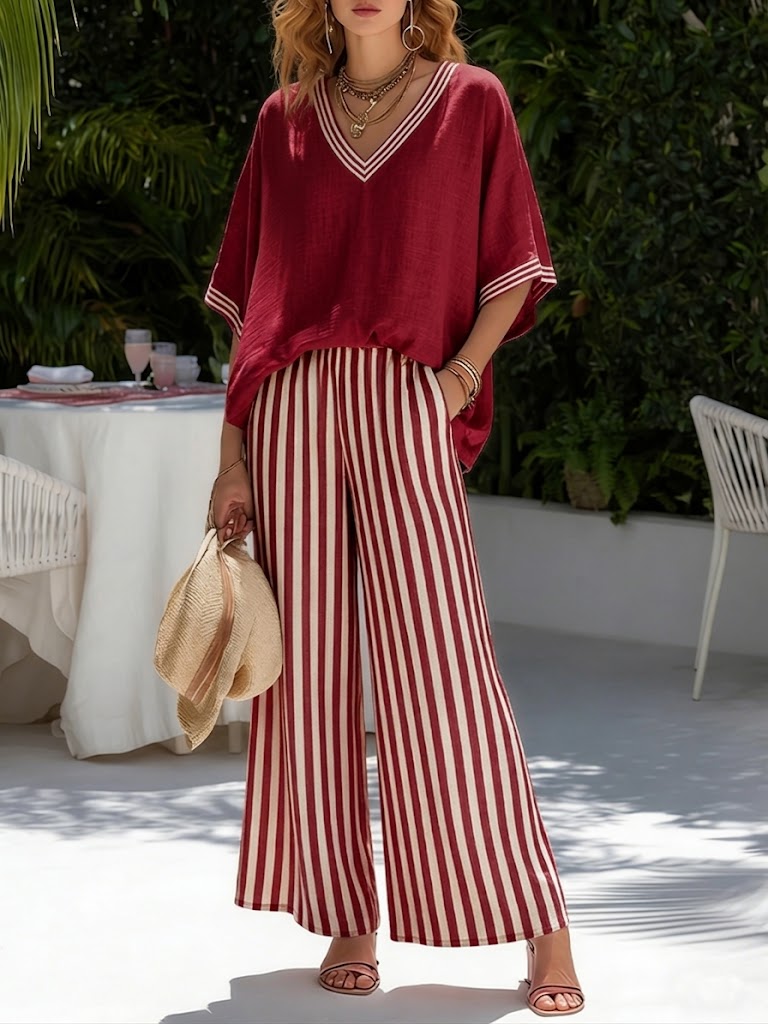 Stylish women's V-neck top with striped wide leg pants. Trendy two-piece outfit for modern fashion.