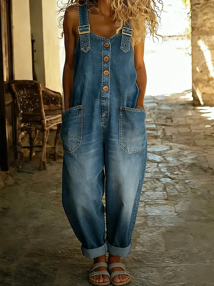 Women's denim jumpsuit, sleeveless wide leg design for a casual & comfy spring/summer look.
