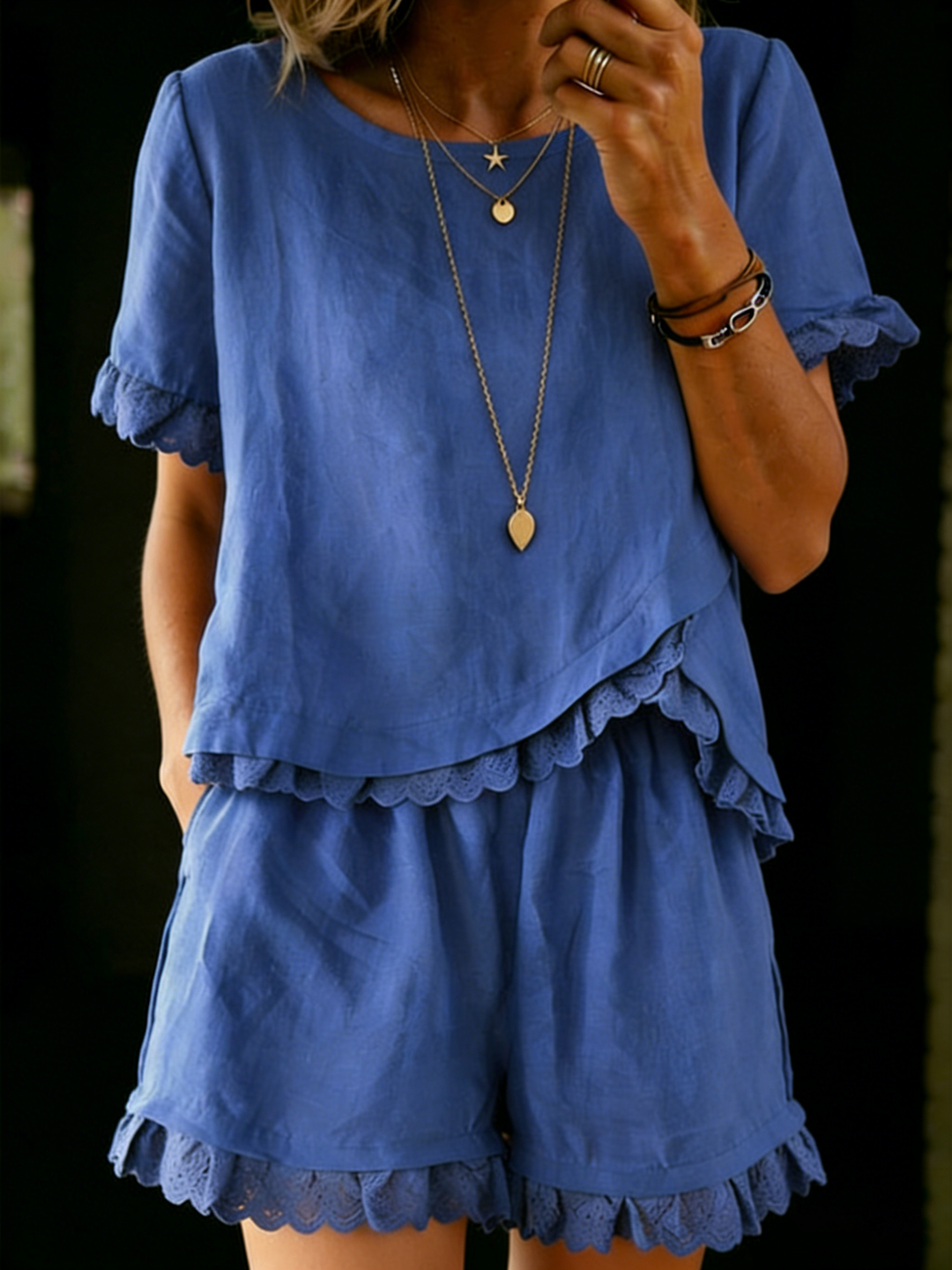 Women's stylish ruffle top & shorts set for summer. Chic two-piece casual resort wear.