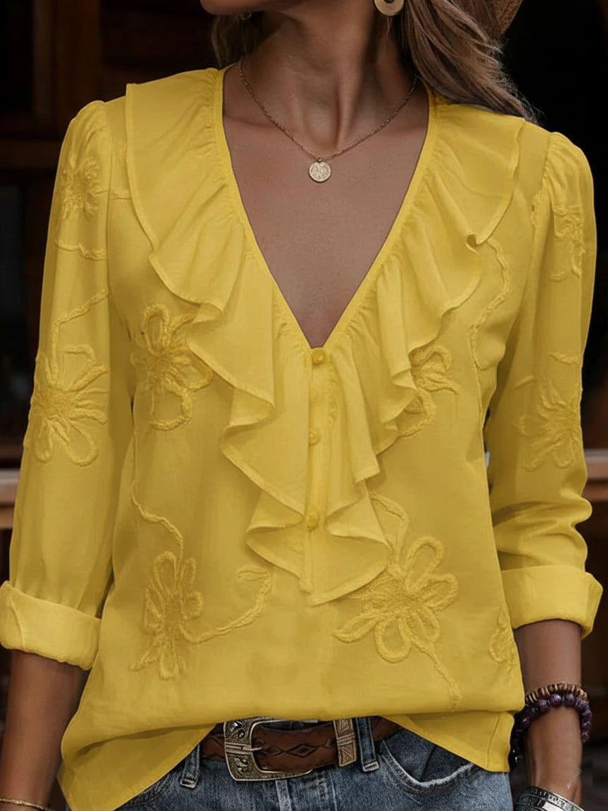 Fashionable women's blouse featuring a V-neck, elegant ruffles, and beautiful floral embroidery. Perfect spring/summer top.