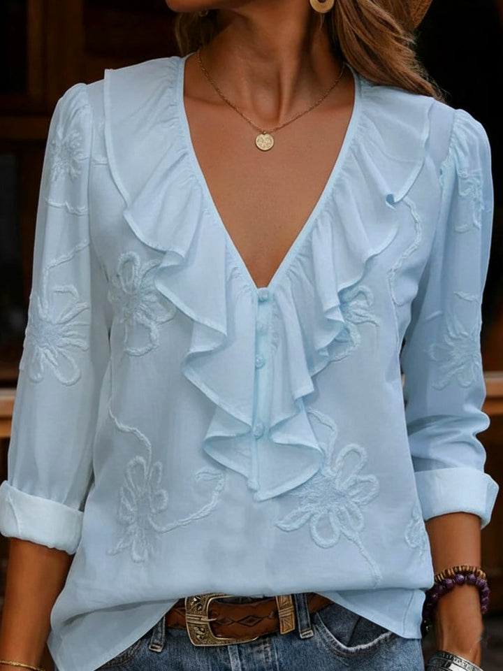 Stylish women's long sleeve top: V-neck blouse with delicate floral embroidery and charming ruffle details.