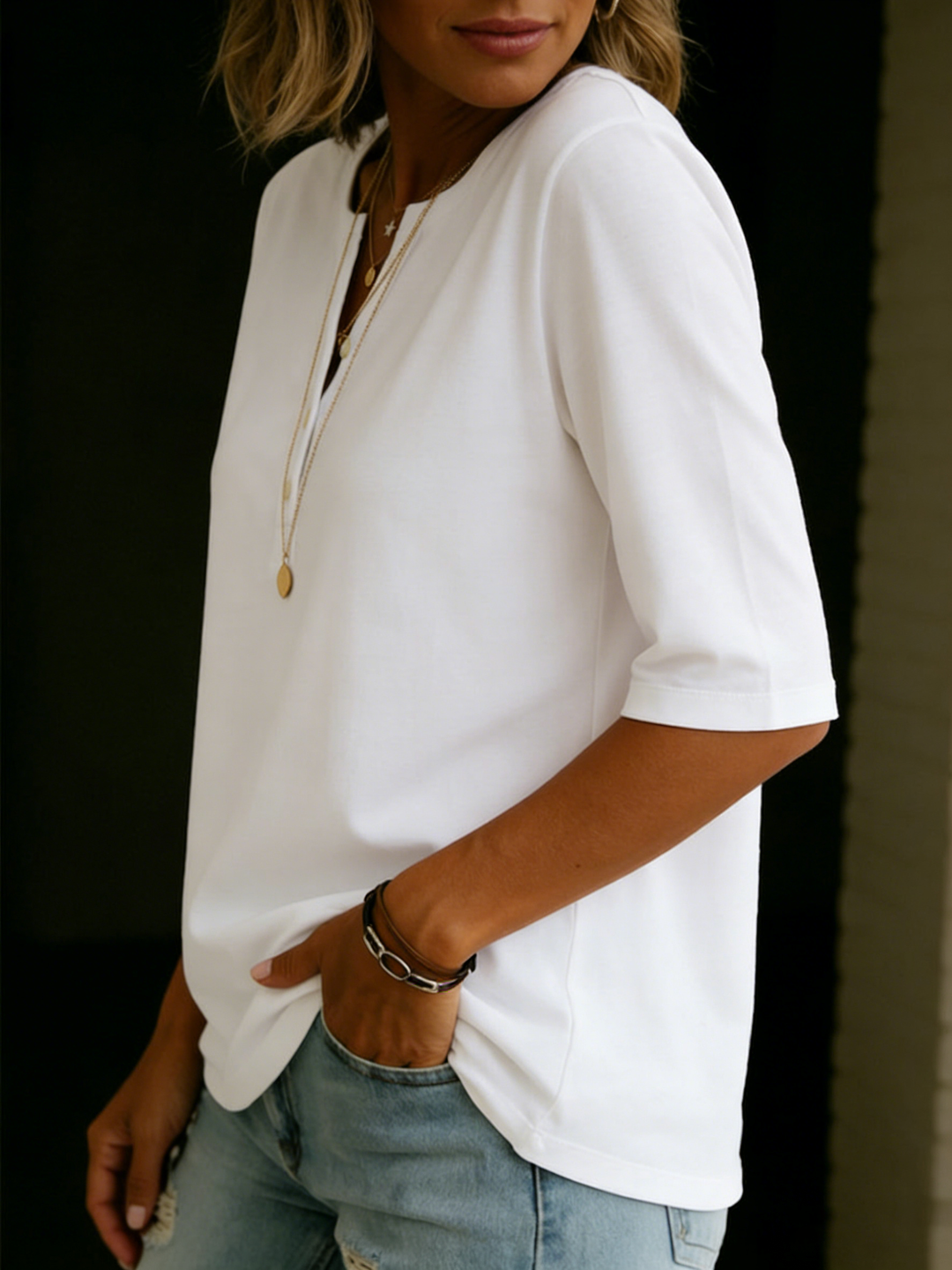 Women's 3/4 sleeve henley shirt with button-up detail. Casual, comfortable top for everyday and summer style.