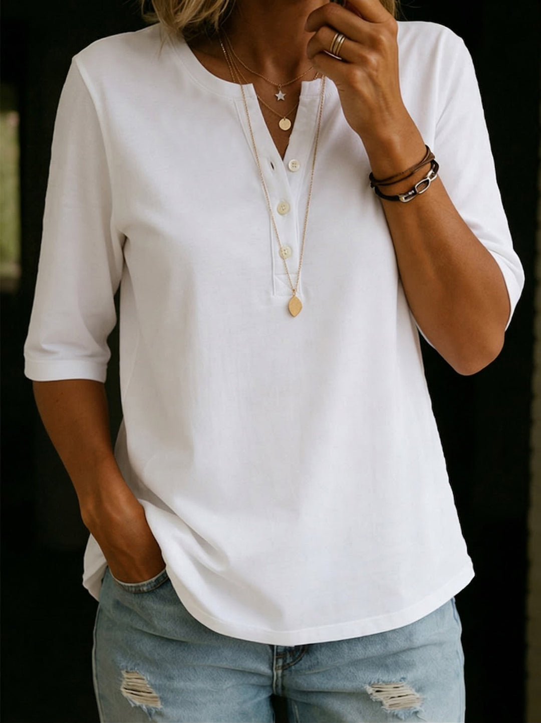 Relaxed fit women's henley shirt. Casual 3/4 sleeve top, versatile for everyday style and spring fashion.