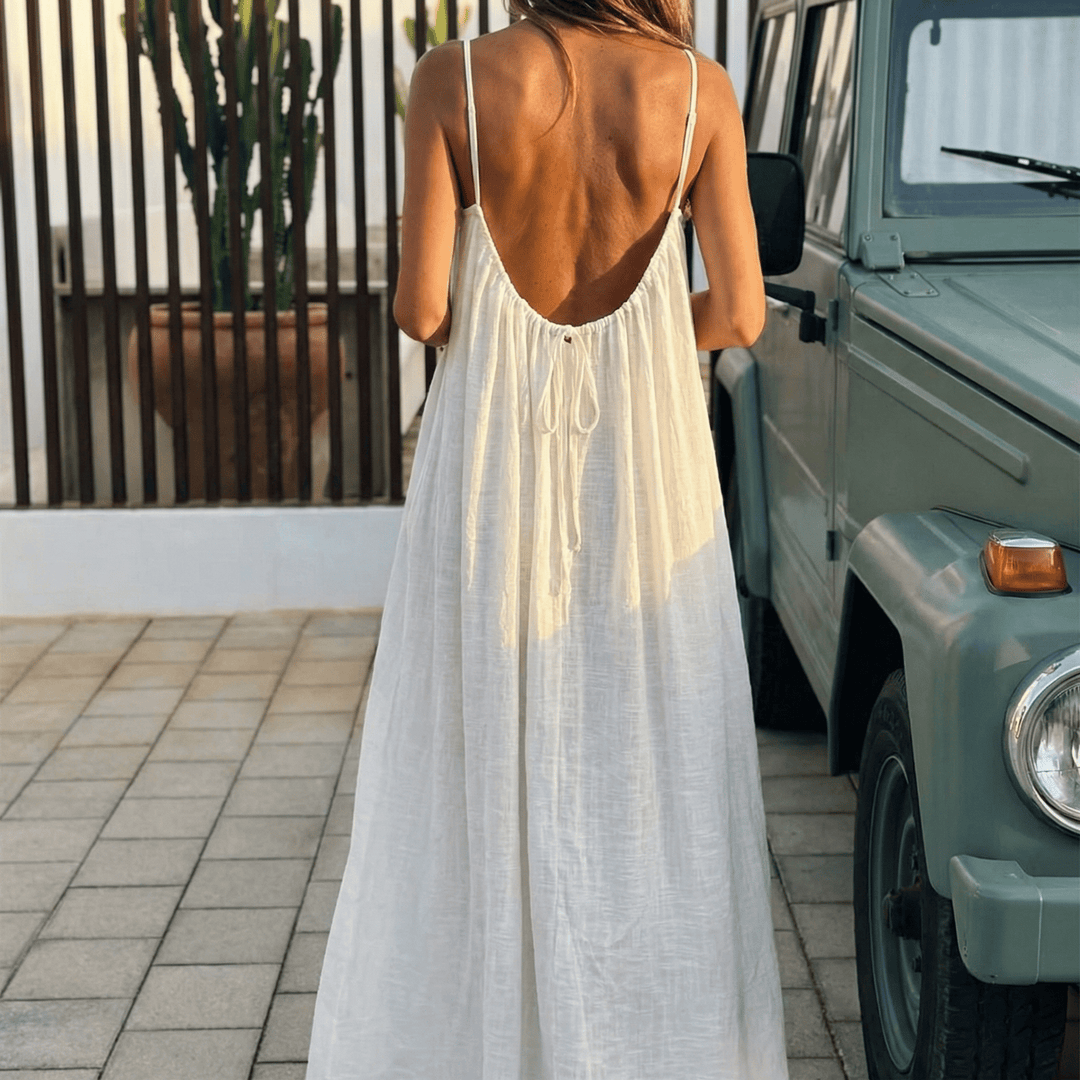 Elegant flowy maxi dress with open back & spaghetti straps, perfect for summer.