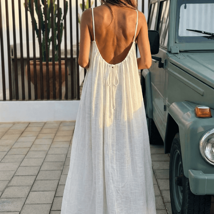 Elegant flowy maxi dress with open back & spaghetti straps, perfect for summer.