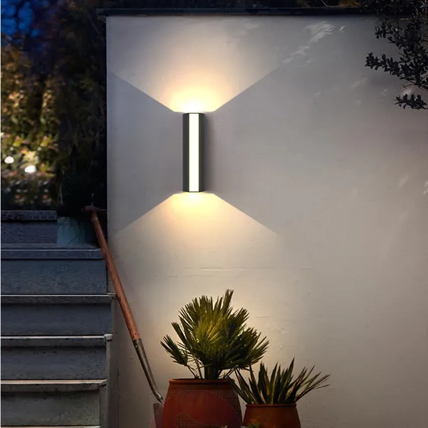 Modern minimalist black LED wall light tube, an energy-efficient exterior fixture for contemporary homes.