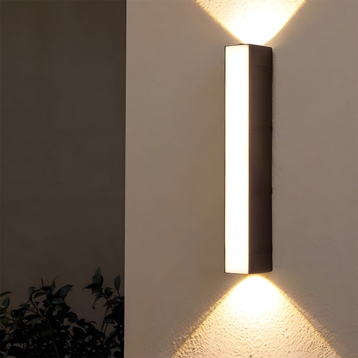 Minimalist black LED tube light, a versatile & energy-efficient modern wall lamp for outdoor or indoor accents.