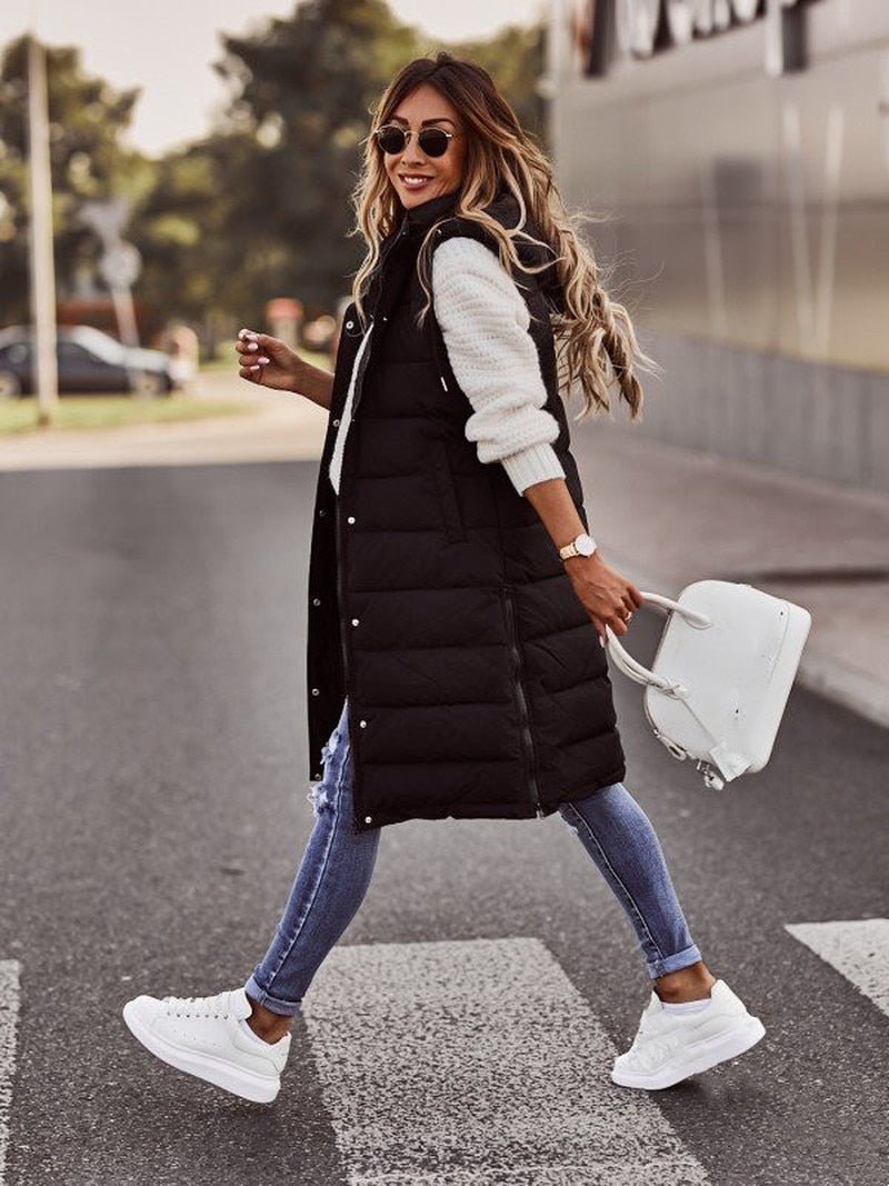 Women's knee-length black quilted puffer jacket, sleek design for warm winter outerwear fashion.