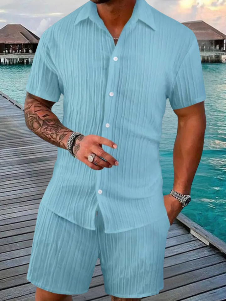 Stylish men's two-piece outfit featuring a casual short sleeve shirt & relaxed fit shorts for summer.