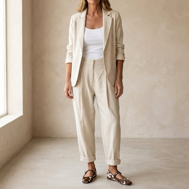 Women's relaxed fit beige blazer & trousers suit set, perfect for business casual or office wear. Chic & versatile.