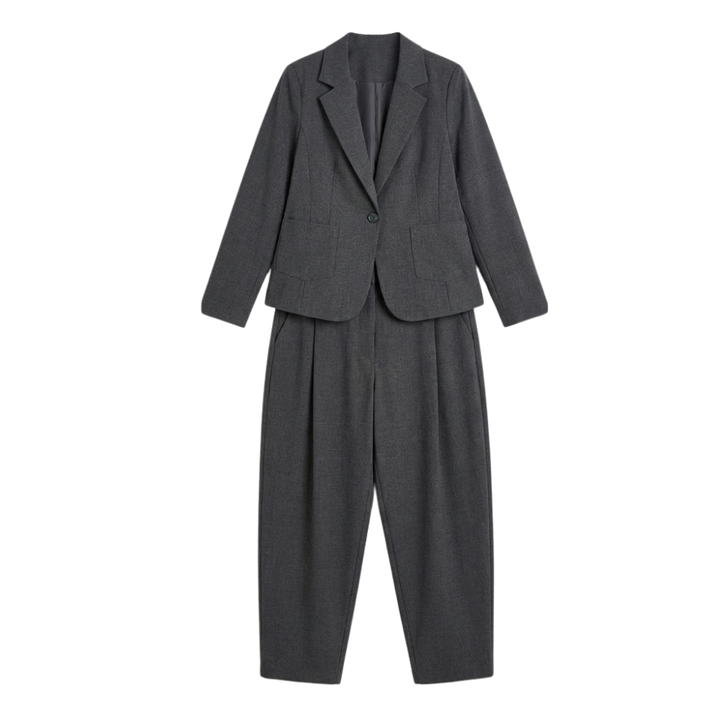 Side view of woman in a relaxed fit beige suit set. Elegant professional attire, perfect for modern women's fashion.