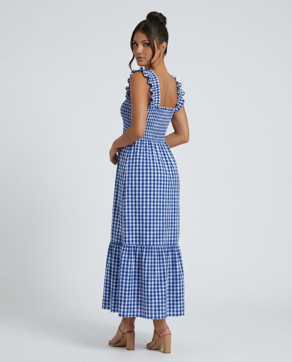 Overhead view of a women's summer maxi dress with gingham pattern, ruffle straps, and smocked bodice.