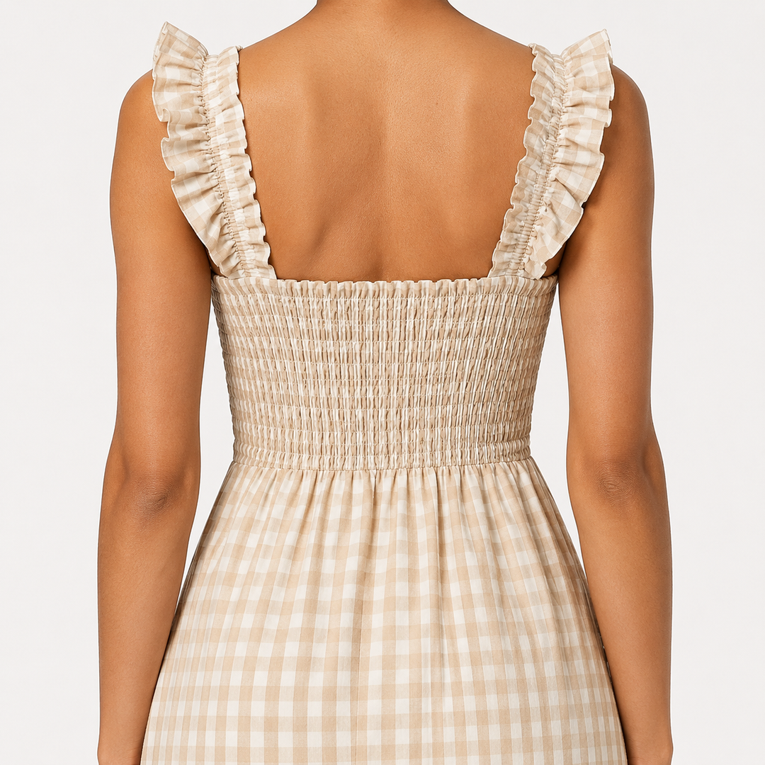 Close-up of the smocked bodice & ruffle straps on a stylish women's gingham maxi dress. Chic summer wear.