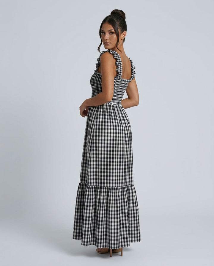Detail of the classic gingham pattern on a women's tiered maxi dress, featuring chic ruffle straps.