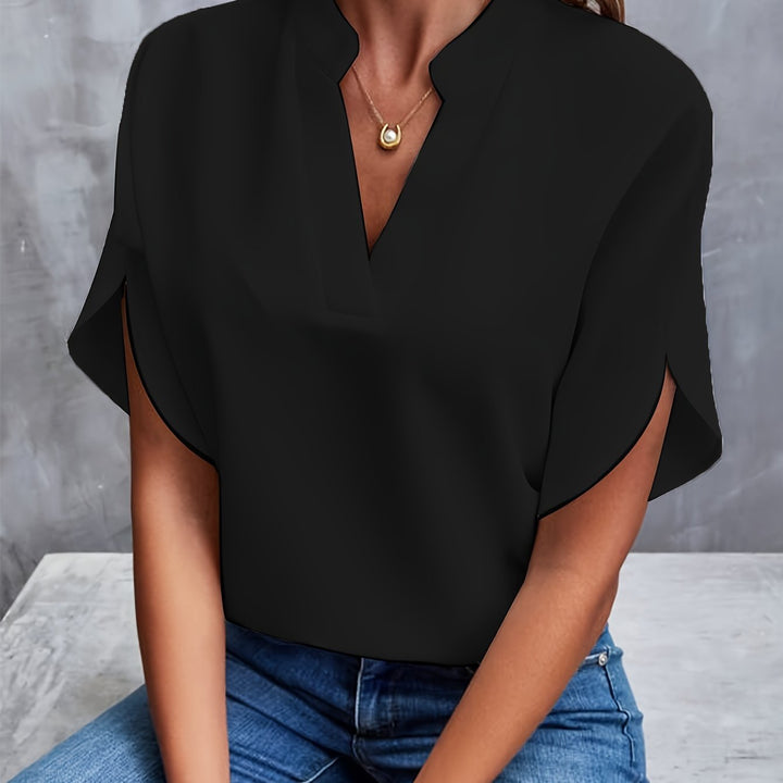Elegant V-neck blouse with batwing sleeves, ideal office wear for women.