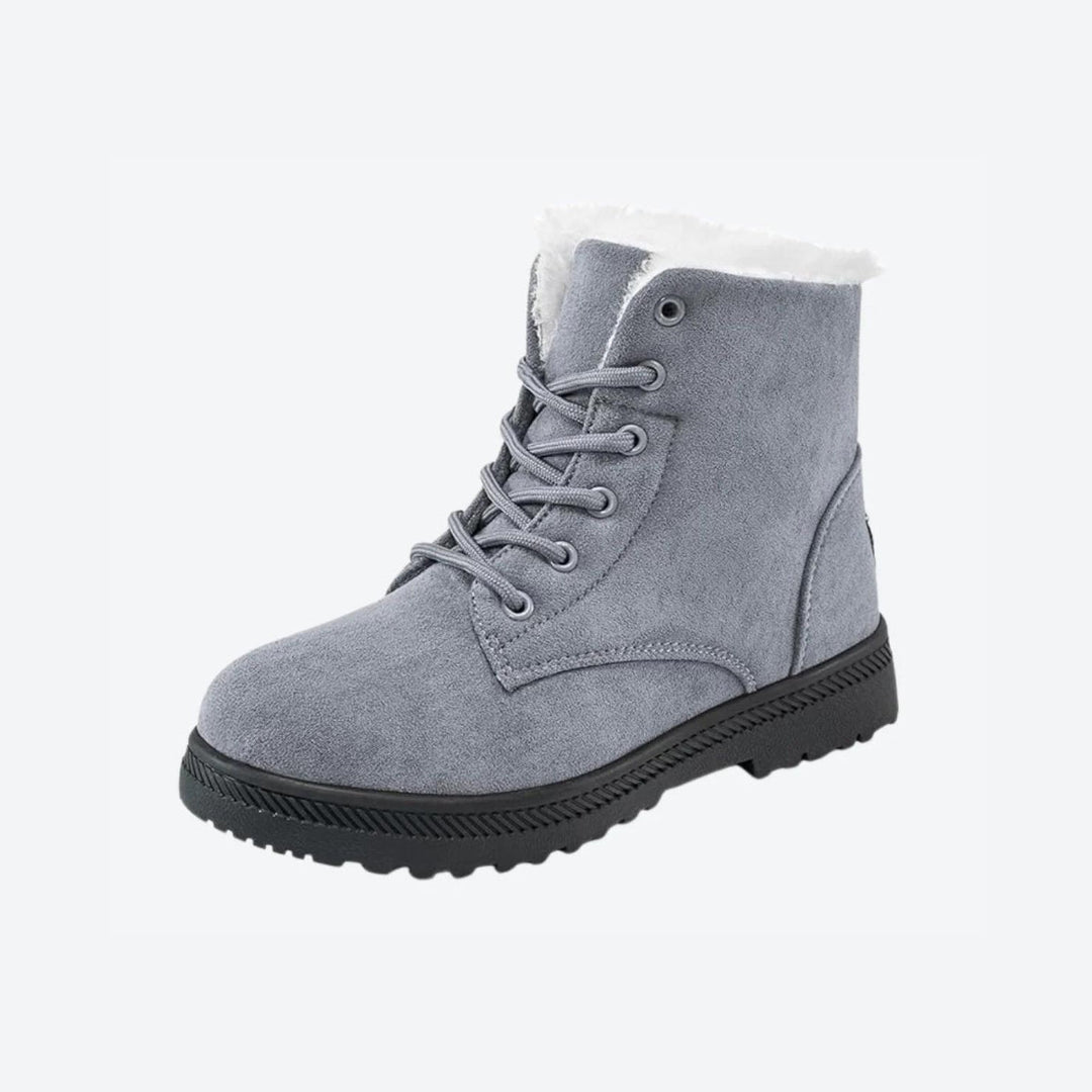 Grey women's snow boots, providing cozy warmth and waterproof comfort in snow.