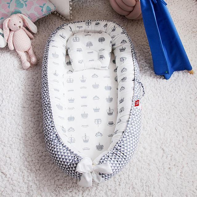 Portable Snuggle Nest baby lounger for infants, perfect for safe newborn sleep and travel.