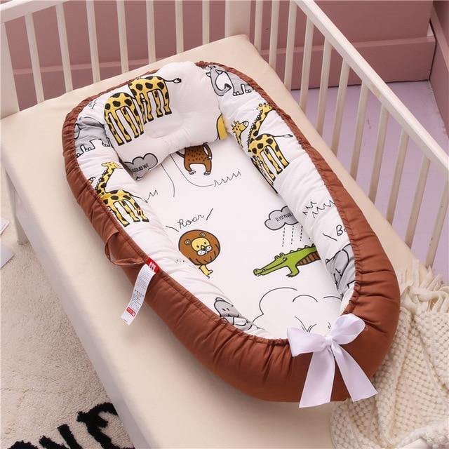 Charming baby lounger in a delightful pattern, offering a secure and comfy spot for newborn rest.