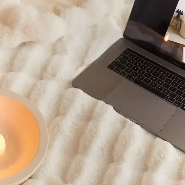 Soft beige VeluLuxe portable faux fur blanket, a luxurious fluffy throw for cozy comfort.