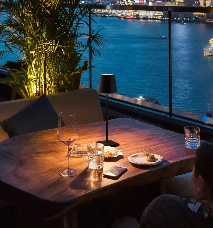 Elegant wireless LED table lamp, dimmable, portable. Provides modern ambient lighting for any contemporary space.