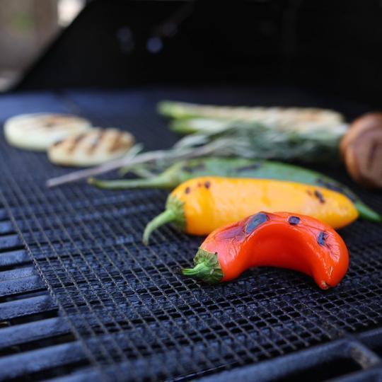 Achieve non-stick BBQ cooking with this heat resistant grill mat. Reusable & easy clean for outdoor kitchens.
