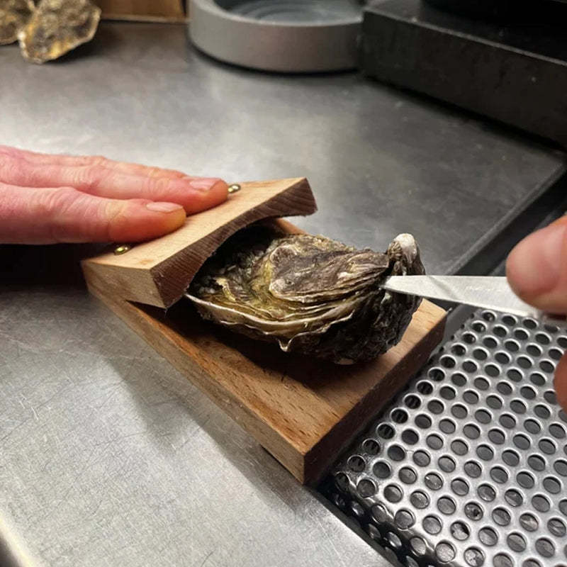 Effortless oyster shucker with ergonomic wood handle. Durable seafood opener for easy shucking.