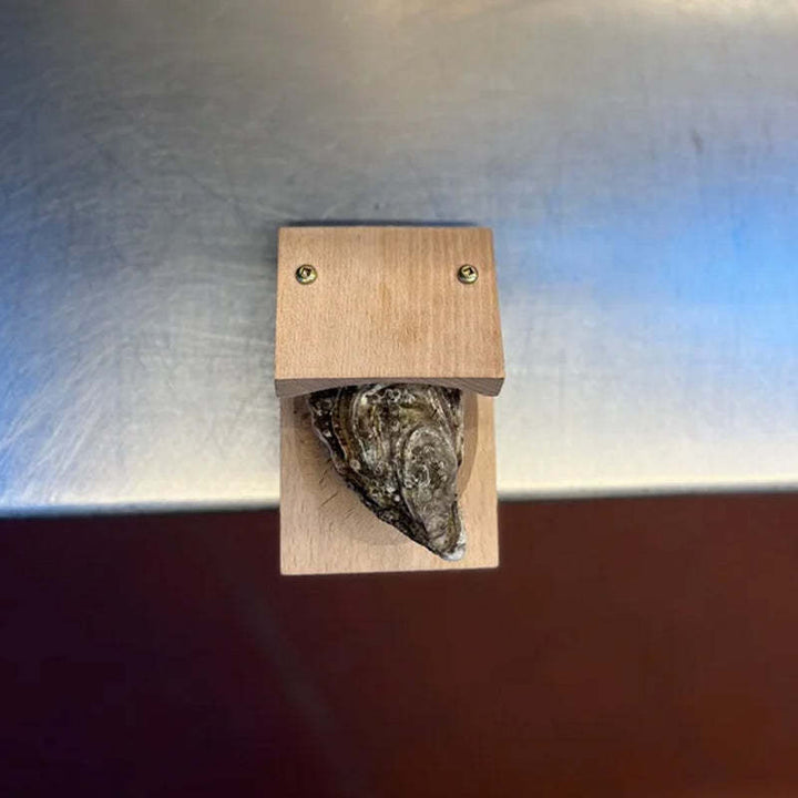 Durable oyster shucker features a sturdy blade & elegant wood handle. Perfect seafood tool for home chefs.