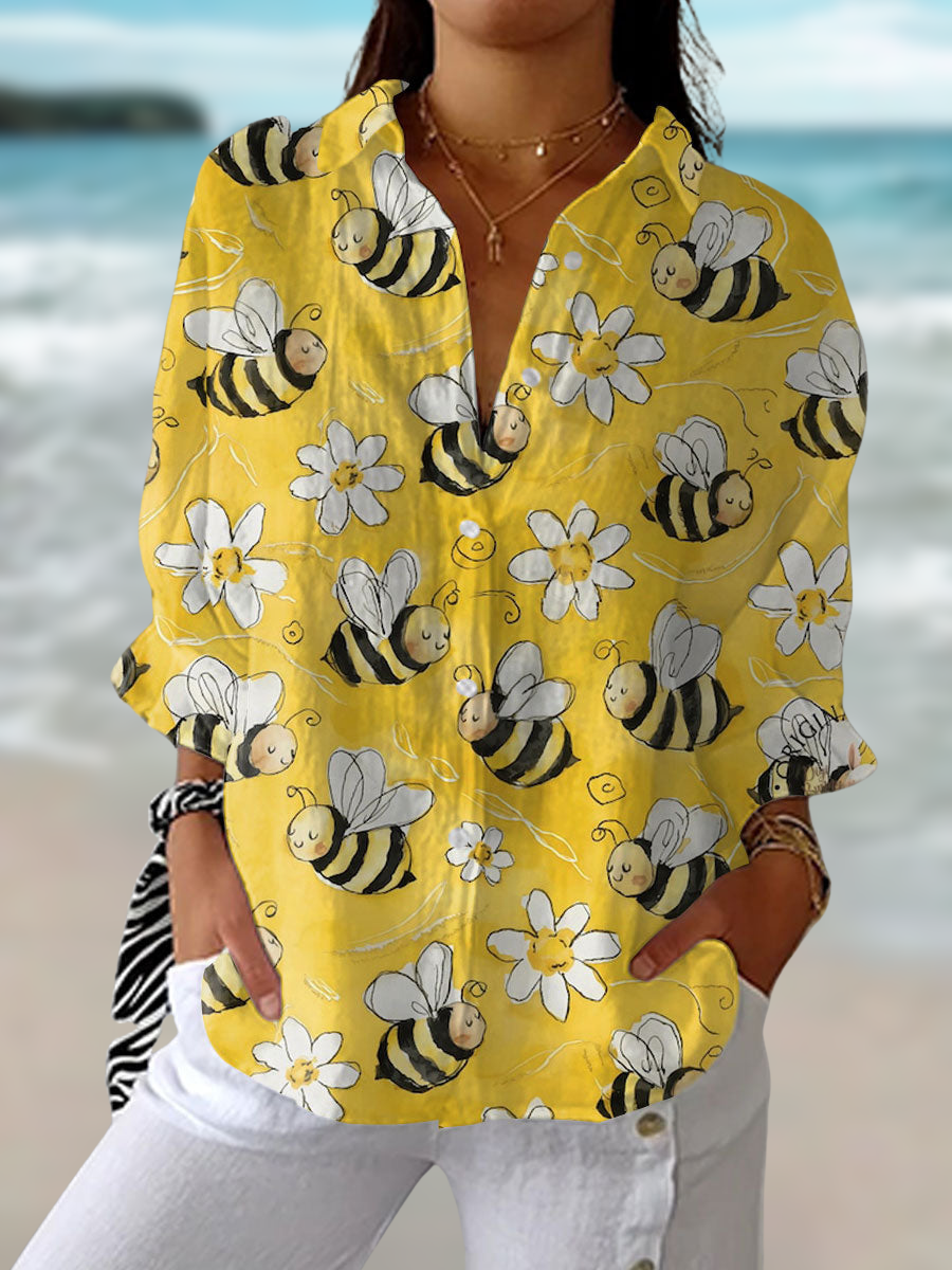 Women's charming long sleeve blouse with playful bee & floral print, perfect for casual spring & summer style.